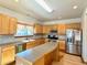 Spacious kitchen with an island, stainless steel appliances, and abundant cabinet space at 395 Longspur Dr, Brighton, CO 80601