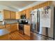 Kitchen features stainless steel refrigerator, wood cabinets and stainless steel oven range at 395 Longspur Dr, Brighton, CO 80601