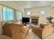 Cozy living room with a fireplace, comfortable seating, and bright natural light at 395 Longspur Dr, Brighton, CO 80601