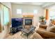 Cozy living area showcasing a fireplace, entertainment center, and comfortable seating at 395 Longspur Dr, Brighton, CO 80601