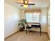Comfortable office with a ceiling fan, natural light from large windows, and neutral decor at 395 Longspur Dr, Brighton, CO 80601