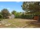 Large backyard with a storage shed and lush landscaping, perfect for outdoor activities and storage at 4425 S Zang St, Morrison, CO 80465