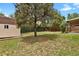 View of the backyard with a storage shed surrounded by trees and lawn at 4425 S Zang St, Morrison, CO 80465