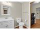 Updated bathroom features a white vanity, toilet, mirror and modern fixtures at 4425 S Zang St, Morrison, CO 80465