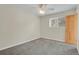 Neutral bedroom features a ceiling fan, window, and light gray carpet at 4425 S Zang St, Morrison, CO 80465