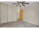 Neutral bedroom features a ceiling fan, closet, and light gray carpet at 4425 S Zang St, Morrison, CO 80465
