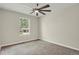 Neutral bedroom features a ceiling fan, window, and light gray carpet at 4425 S Zang St, Morrison, CO 80465