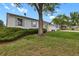 Landscaped front yard showcasing a mature tree, well-maintained lawn, and the home's exterior at 4425 S Zang St, Morrison, CO 80465