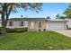 Charming single-story home featuring a well-manicured lawn, brick accents, and a two-car garage at 4425 S Zang St, Morrison, CO 80465