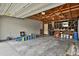 View of the spacious garage featuring exposed ceiling and ample storage for parking and hobbies at 4425 S Zang St, Morrison, CO 80465