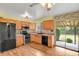 Kitchen features wood cabinets, modern appliances, and sliding glass door to backyard at 4425 S Zang St, Morrison, CO 80465