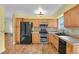 Bright kitchen features wood cabinets, modern appliances, tile backsplash, and wood floors at 4425 S Zang St, Morrison, CO 80465