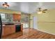 Updated kitchen featuring wood cabinets, granite countertops, and sliding glass door to backyard at 4425 S Zang St, Morrison, CO 80465
