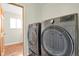 Modern laundry room with side-by-side, front-loading washer and dryer at 4425 S Zang St, Morrison, CO 80465