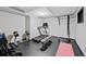Finished basement gym with rubber flooring, workout equipment, and a pull up bar at 5775 S Pagosa Way, Centennial, CO 80015