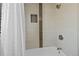 This bathroom includes an updated shower and bathtub with light colored tile at 5775 S Pagosa Way, Centennial, CO 80015