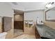 Updated bathroom with granite countertops, vessel sink, tile flooring, and custom shower at 5775 S Pagosa Way, Centennial, CO 80015
