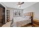 This bedroom offers neutral walls, a wood framed bed, and a ceiling fan at 5775 S Pagosa Way, Centennial, CO 80015