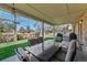 Relaxing covered patio featuring an outdoor dining area and a backyard with green grass, ideal for entertaining at 5775 S Pagosa Way, Centennial, CO 80015