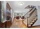 Spacious entryway featuring hardwood floors, stairs with carpet and dark wood trim and a view into the living room at 5775 S Pagosa Way, Centennial, CO 80015