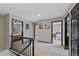 Upstairs hallway featuring a view of bedrooms and updated lighting at 5775 S Pagosa Way, Centennial, CO 80015