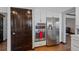 Gourmet kitchen with stainless steel appliances and a stylish dark door, seamlessly blending function and aesthetic appeal at 5775 S Pagosa Way, Centennial, CO 80015