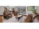 Cozy living room featuring hardwood floors, neutral paint, and leather furniture arranged around a coffee table at 5775 S Pagosa Way, Centennial, CO 80015