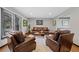 Cozy living room featuring hardwood floors, neutral paint, and leather furniture arranged around a coffee table at 5775 S Pagosa Way, Centennial, CO 80015