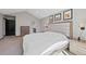 This main bedroom offers neutral walls, carpet, and a large upholstered headboard with modern lighting at 5775 S Pagosa Way, Centennial, CO 80015