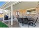 Covered outdoor patio with dining table set and grill, perfect for entertaining at 5775 S Pagosa Way, Centennial, CO 80015