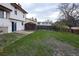 Large backyard with mature trees, a lawn, storage shed, wooden fence, and easy access to the home at 530 S Laredo Cir, Aurora, CO 80017
