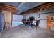 Unfinished basement with exposed ceiling, concrete floor, and furniture at 530 S Laredo Cir, Aurora, CO 80017
