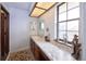 Bathroom with a marble countertop, under sink cabinetry, and a large window at 530 S Laredo Cir, Aurora, CO 80017