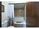 Bathroom with a white bathtub and shower with a floral shower curtain next to a white toilet at 530 S Laredo Cir, Aurora, CO 80017