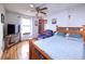 Bedroom featuring a ceiling fan, wood floors, bed and a television at 530 S Laredo Cir, Aurora, CO 80017