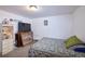 Cozy bedroom with a simple, patterned bed and a curio cabinet for storage at 530 S Laredo Cir, Aurora, CO 80017