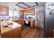 Bright kitchen featuring wooden cabinets, a stainless steel refrigerator, butcher block countertops, and modern appliances at 530 S Laredo Cir, Aurora, CO 80017