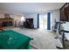 Large carpeted living room area with brick fireplace and sliding door access at 530 S Laredo Cir, Aurora, CO 80017