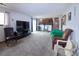 Carpeted living room features a television, fireplace, and sliding glass doors to the backyard at 530 S Laredo Cir, Aurora, CO 80017