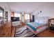 A well lit, spacious bedroom with wood floors, a flat screen tv, and ample closet space at 530 S Laredo Cir, Aurora, CO 80017