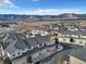 An aerial view of modern homes with garages, a neighborhood street, and a picturesque mountain range backdrop at 726 Vista Verde Hts, Monument, CO 80132