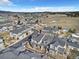 A high-angle view displays townhomes with garages amidst a community setting and open land at 726 Vista Verde Hts, Monument, CO 80132