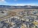 An aerial view of a neighborhood nestled against mountains, showcasing the community's layout and scenic surroundings at 726 Vista Verde Hts, Monument, CO 80132