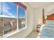 Bedroom view showcasing a scenic neighborhood with a four-poster bed and a bright sunny window at 726 Vista Verde Hts, Monument, CO 80132