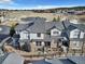 Townhome exterior featuring a stone facade, small yard and attached garage at 726 Vista Verde Hts, Monument, CO 80132