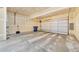 Spacious garage interior featuring a large garage door, concrete floor, and ample space at 726 Vista Verde Hts, Monument, CO 80132