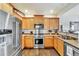 Well-equipped kitchen with stainless steel appliances, wooden cabinets, and a functional layout for cooking at 726 Vista Verde Hts, Monument, CO 80132