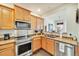 Bright kitchen boasts stainless steel appliances and light wood cabinetry at 726 Vista Verde Hts, Monument, CO 80132