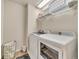 Laundry room featuring a modern washer and dryer, sleek flooring, a laundry basket, and storage shelves at 726 Vista Verde Hts, Monument, CO 80132