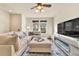 Cozy living room with large sectional, modern fireplace, and natural light at 726 Vista Verde Hts, Monument, CO 80132